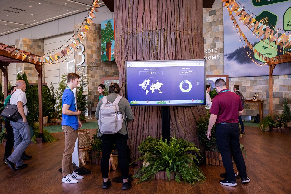 People visiting the Net Zero Vista at Dreamforce learn more about Net Zero Marketplace.